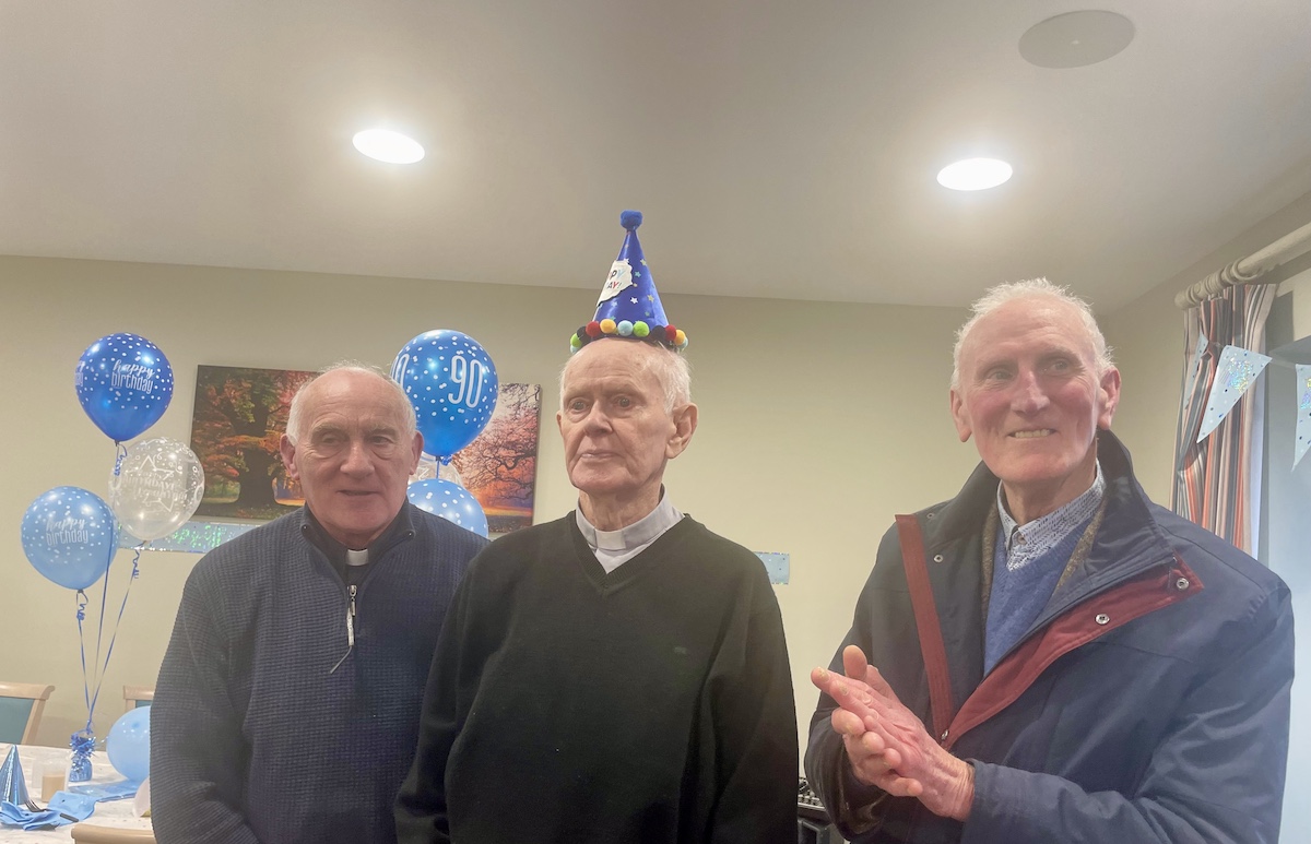 Resident smiling with friends at birthday party