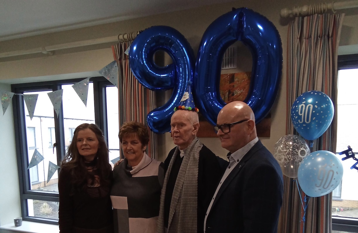 Resident smiling with friends at birthday